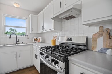 Kitchen featuring stainless steel gas range, a si