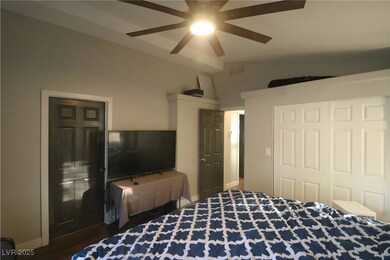Bedroom featuring vaulted ceiling, a ceiling fan, a closet, and wood finished floors