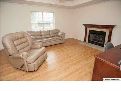 Relax in the family room complete with gas log fireplace, laminate floors, and trey ceiling.