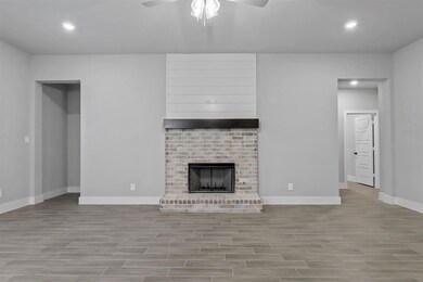 Unfurnished living room featuring ceiling fan, lig