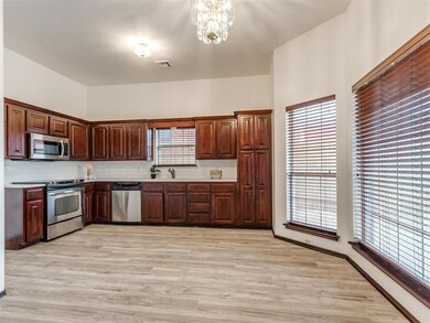 Kitchen with an inviting chandelier, tasteful back