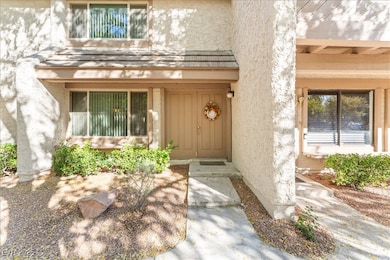View of exterior entry with stucco siding