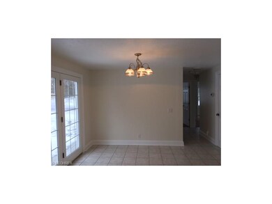French doors in eat-in kitchen lead to spacious de