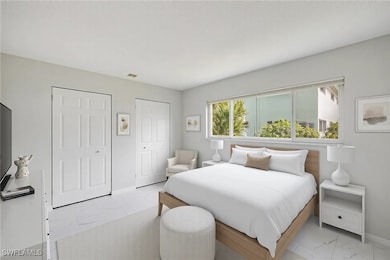 Bedroom featuring baseboards, two closets, and til