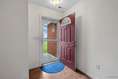 Foyer featuring light wood-style floors and a text