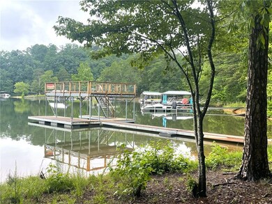 Dock with a water view and a wooded view