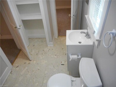 Main Bathroom: Room features include vinyl flooring for easy cleaning, fresh paint, a window for natural lighting and crown molding. This is a Jack-N-Jill bathroom and is shared with bedroom two. The door to the left is from the primary bedroom and the open door in the middle is from bedroom two.