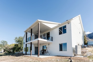 Rear view of house featuring a patio and ceiling fan