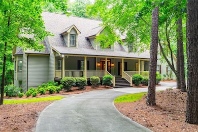 View of front facade with covered porch, driveway,