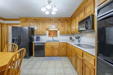 Spacious kitchen with tile flooring, plenty of cab