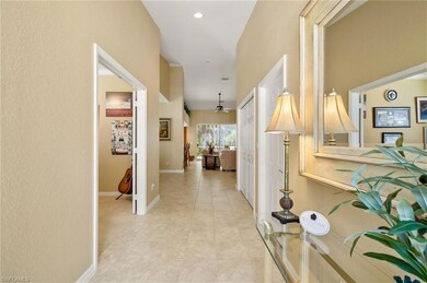 Hallway with light tile patterned flooring, basebo