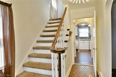 Stairway with tile flooring and sink