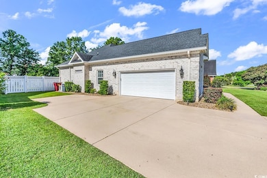 View of front of property featuring brick siding, a shingled roof, concrete driveway, and a garage