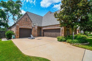 Large driveway with 3 attached garages and side en