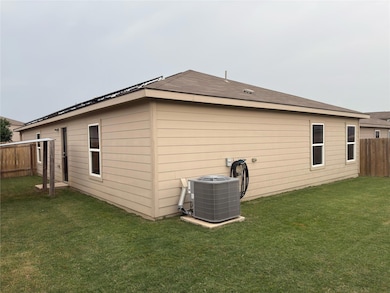 Rear view of house with central AC