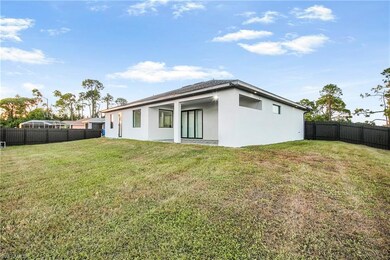 Rear view of house featuring a fenced backyard, stucco siding, and a patio