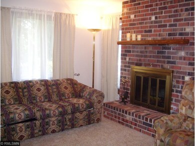 Living room features wood burning fireplace. New c