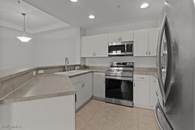 Kitchen featuring white cabinetry, appliances with