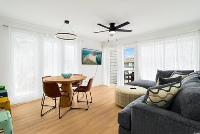 Living area featuring light wood-style flooring and ceiling fan