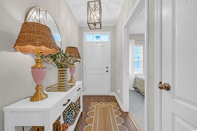 Foyer entrance with dark wood-style floors, a nota