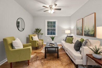Living room featuring ceiling fan and hardwood / w