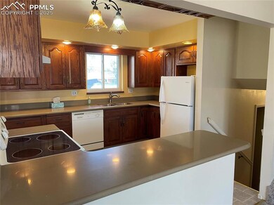 Kitchen with pendant lighting, sink, and white app