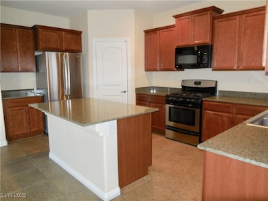 Kitchen with stainless steel appliances, stone cou