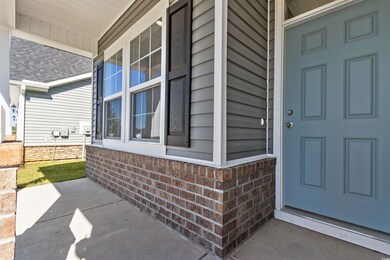 View of exterior entry featuring covered porch