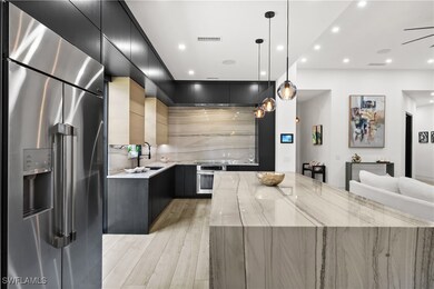 Kitchen with hanging light fixtures, sink, a large