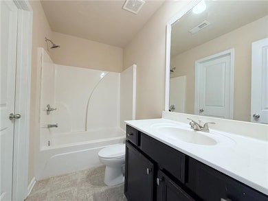 Bathroom featuring vanity and bathing tub / shower combination