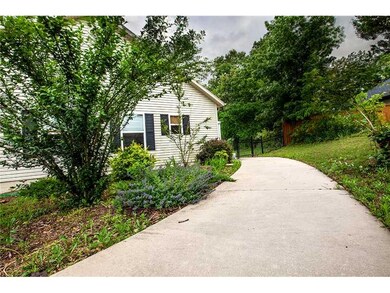 Exterior Back/Side. Walkway from driveway to fenced backyard.