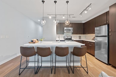 Kitchen featuring a kitchen breakfast bar, a sink