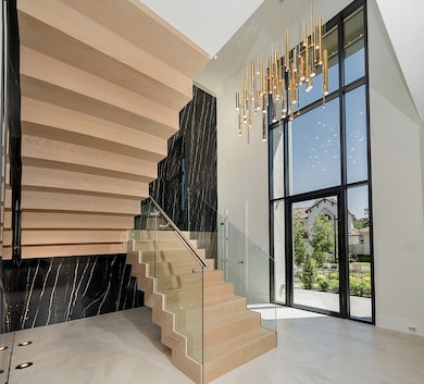 Structural steel floating staircase with tempered