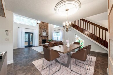 You enter into a spacious LIVING & DINING AREA, the many windows offer nice NATURAL LIGHT, the VAULTED CEILING adds to the open feel and TILE FLOORS make maintenance easy! Virtually Staged.