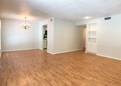 Spare room with a notable chandelier, a textured 