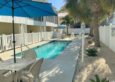 Pool with outdoor dining space, a patio area, and a fenced backyard