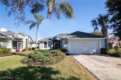 Ranch-style home with a front lawn and a garage
