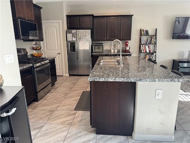 Kitchen featuring stainless steel appliances, dark