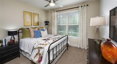 Bedroom featuring light carpet and ceiling fan