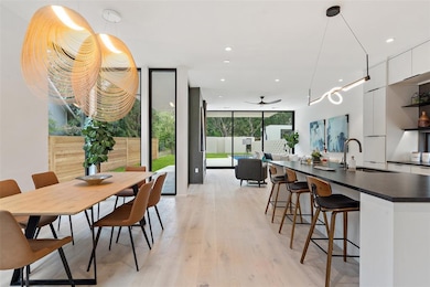 Dining area with a wall of windows, a ceiling fan