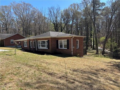 View of front of house with brick siding and a fro