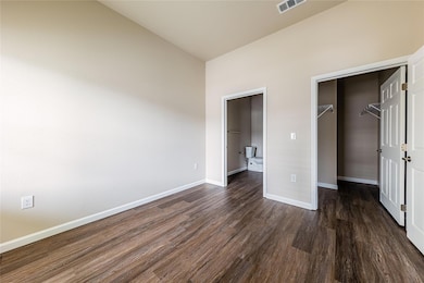 Unfurnished bedroom featuring a walk in closet, d
