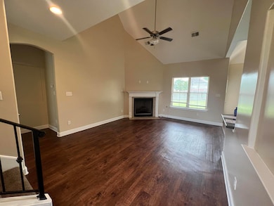 Unfurnished living room with arched walkways, high