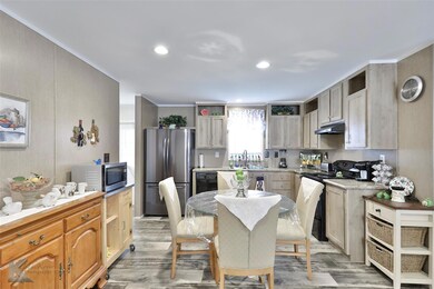 Kitchen with black appliances, light brown cabinet