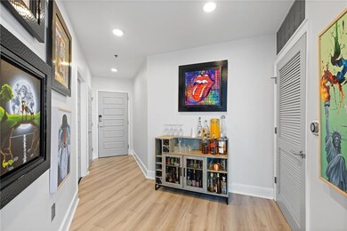 Foyer entrance featuring wood finished floors, recessed lighting, a bar, and baseboards