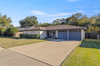 Ranch-style house featuring driveway, a garage, and brick siding