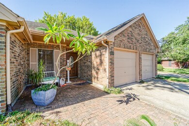 A covered front porch, adorned with elegant brick pavers.