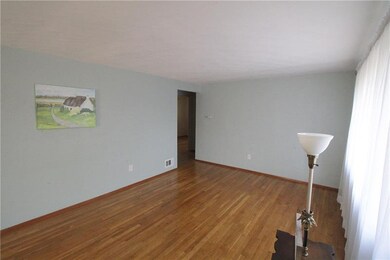 Living Room with exposed hardwood flooring.