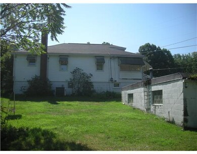 Exterior Back. Side of house with detached double 