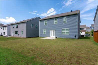 Back of property featuring a patio and a lawn
